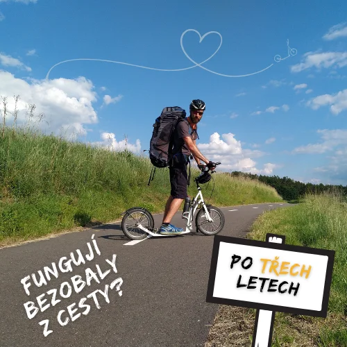 Autor blogu na městské koloběžce na asfaltové cyklostezce, za ním modré nebe s obláčky